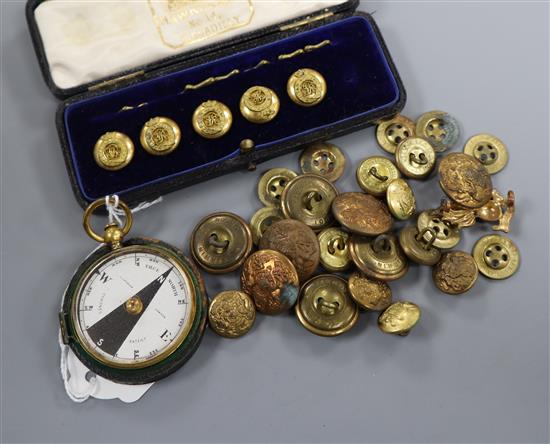 A collection of military buttons and a compass.